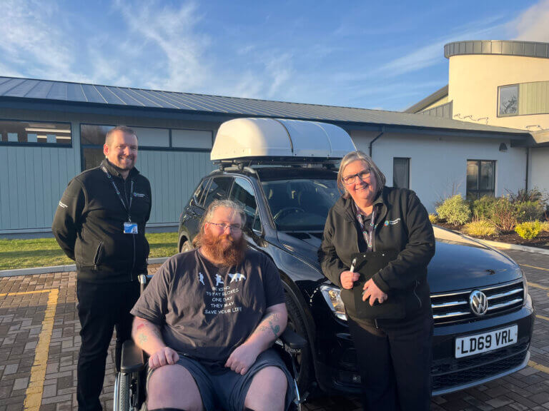 David in front of car